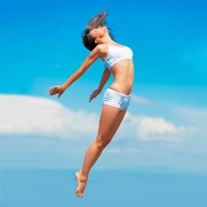 Propelled by an energy boost. A young woman in mid-air with